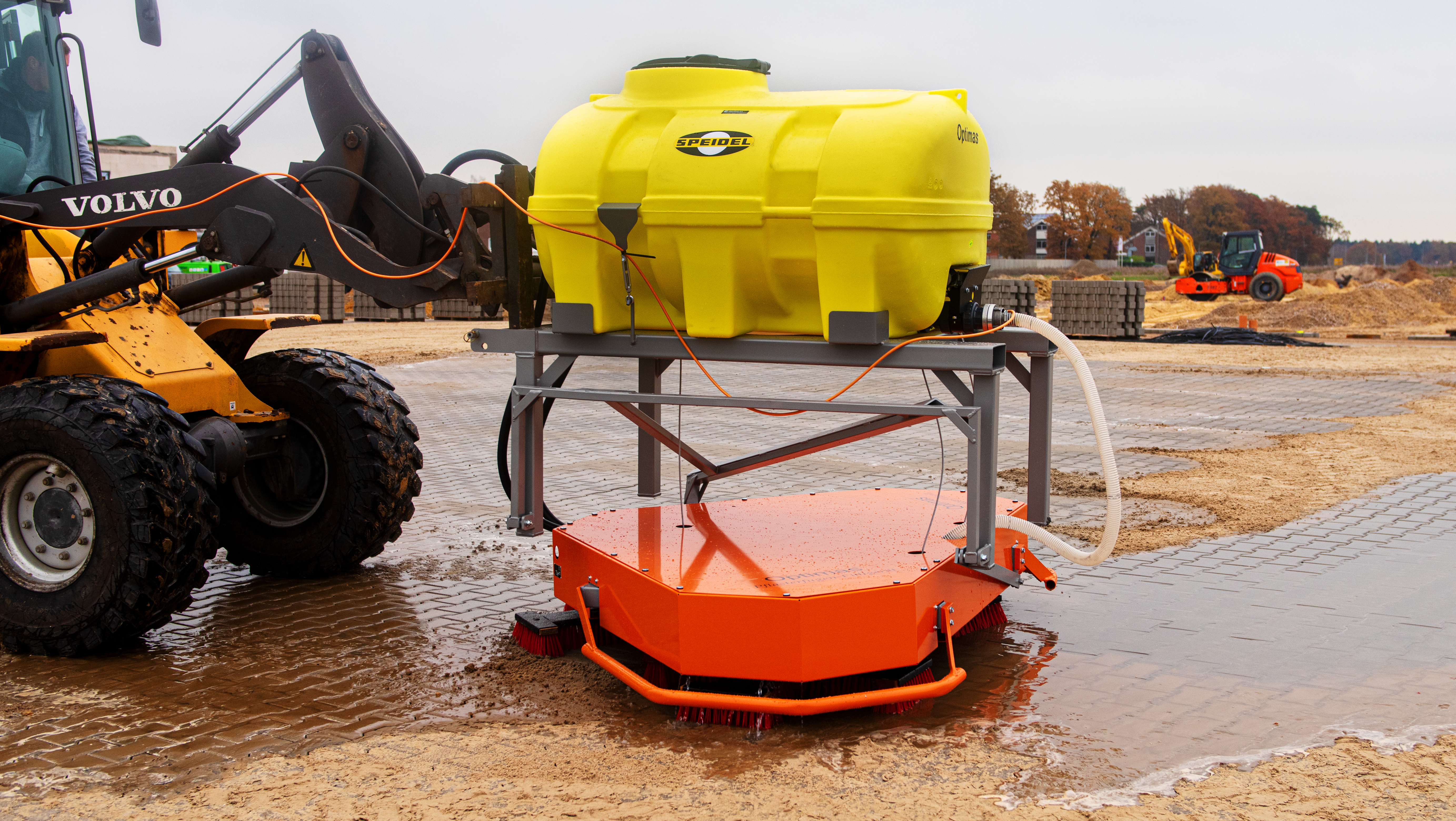 A yellow tank mounted on a frame with an orange base, used for construction site applications – Optimas.