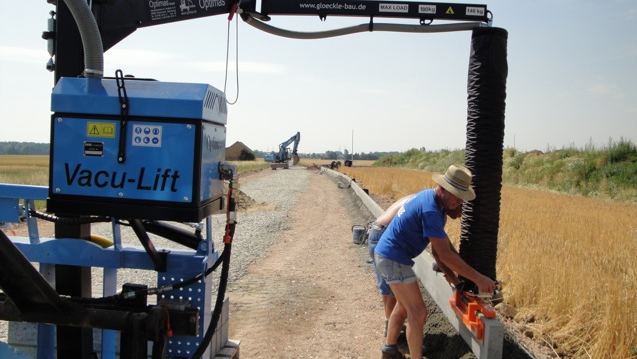 Road construction with Optimas Vacu-Lift: easy placing of curbs.